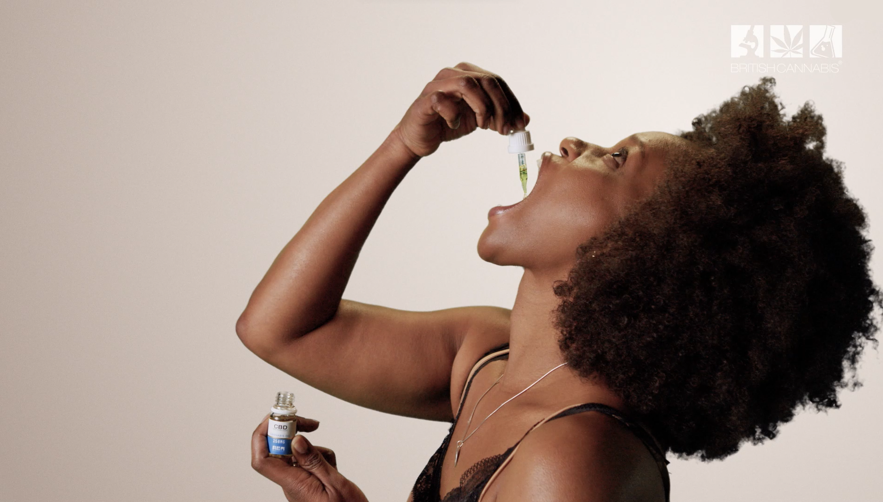 A woman is pictured taking CBD oil in the mouth